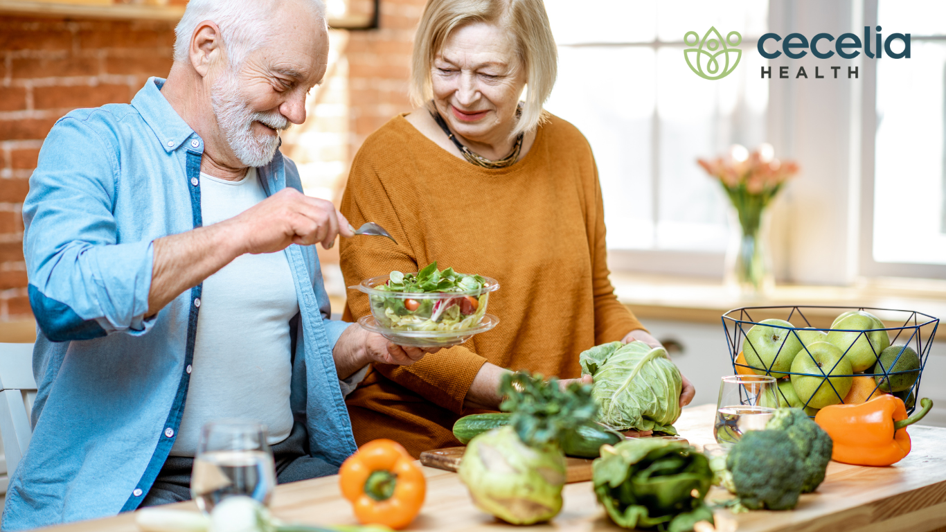 older couple making a salad together