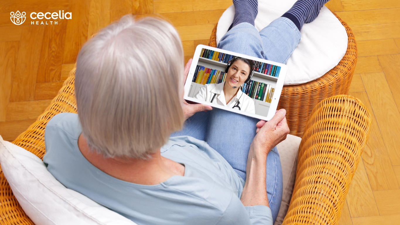 woman on tablet for proactive virtual specialty care visit with doctor
