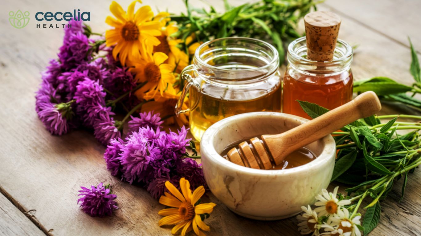 collection of herbs flowers and honey