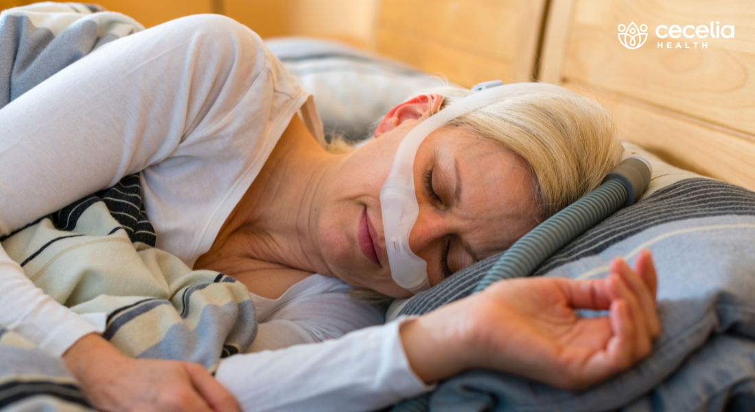 woman sleeping in bed with CPAP machine
