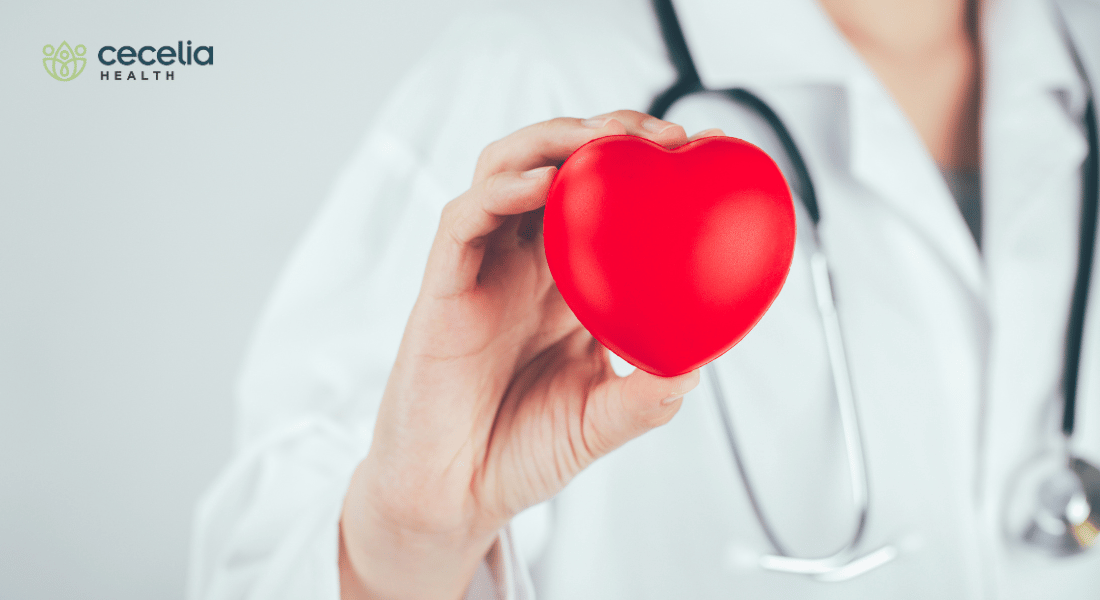 doctor holding up heart symbol