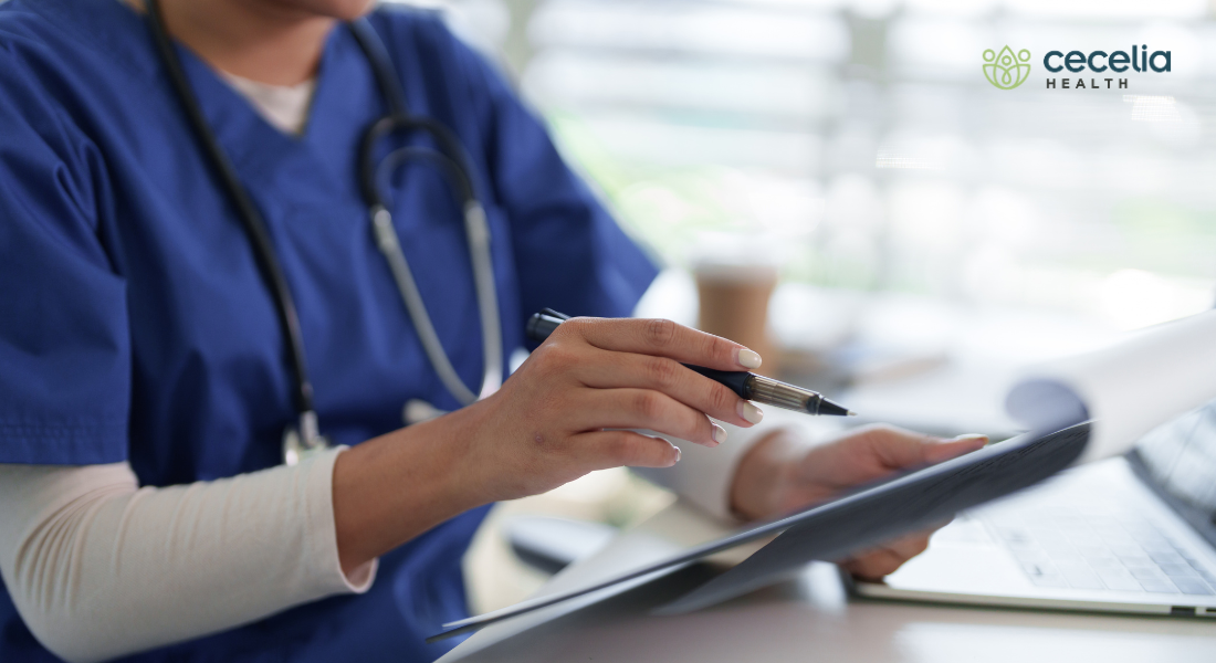 clinician looking at lab results on clipboard