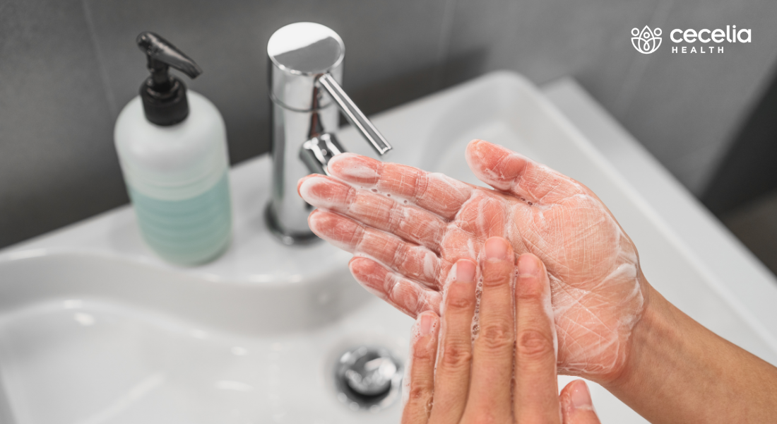 person washing their hands with soap
