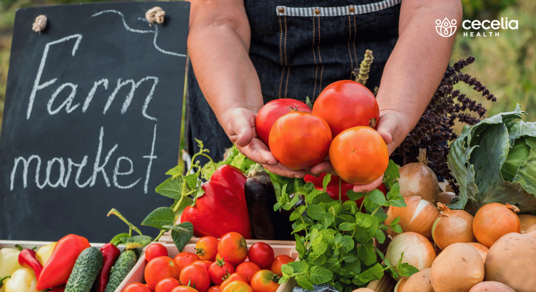 person holding fruits at a farmers market