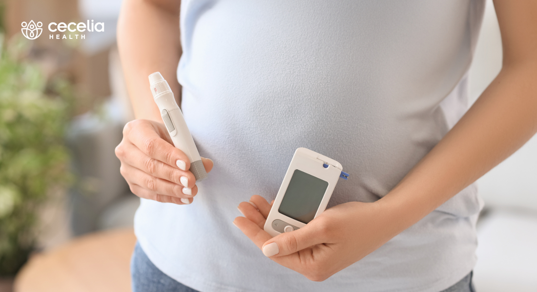 pregnant woman holding insulin pen and blood glucose monitor