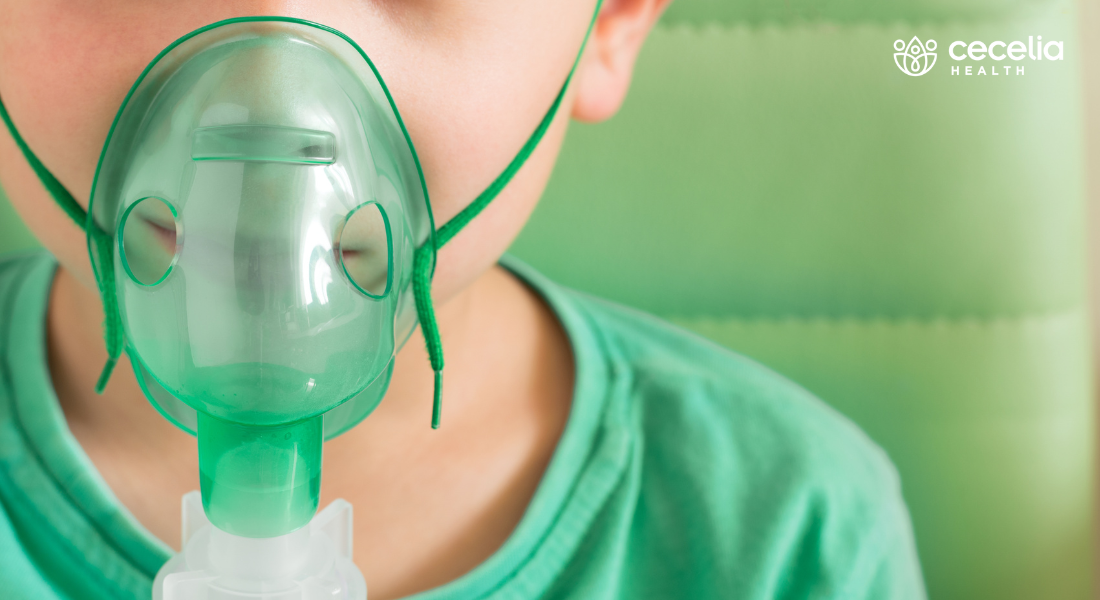 young child with medical inhaler device strapped to face