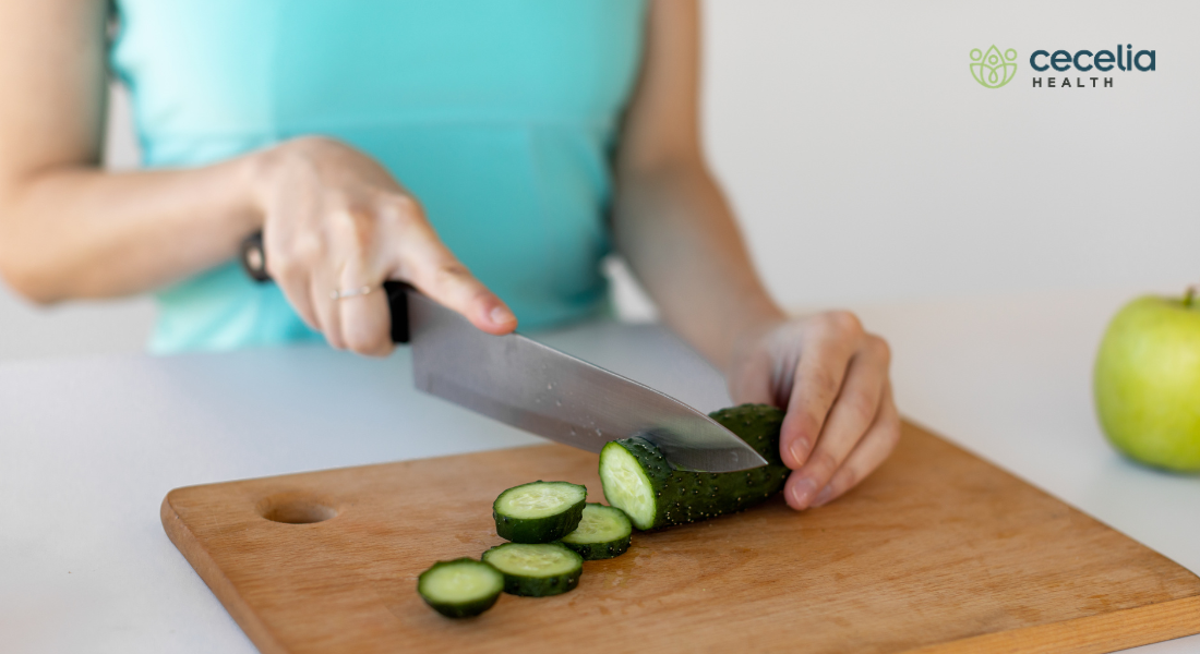 woman chopping cucumber