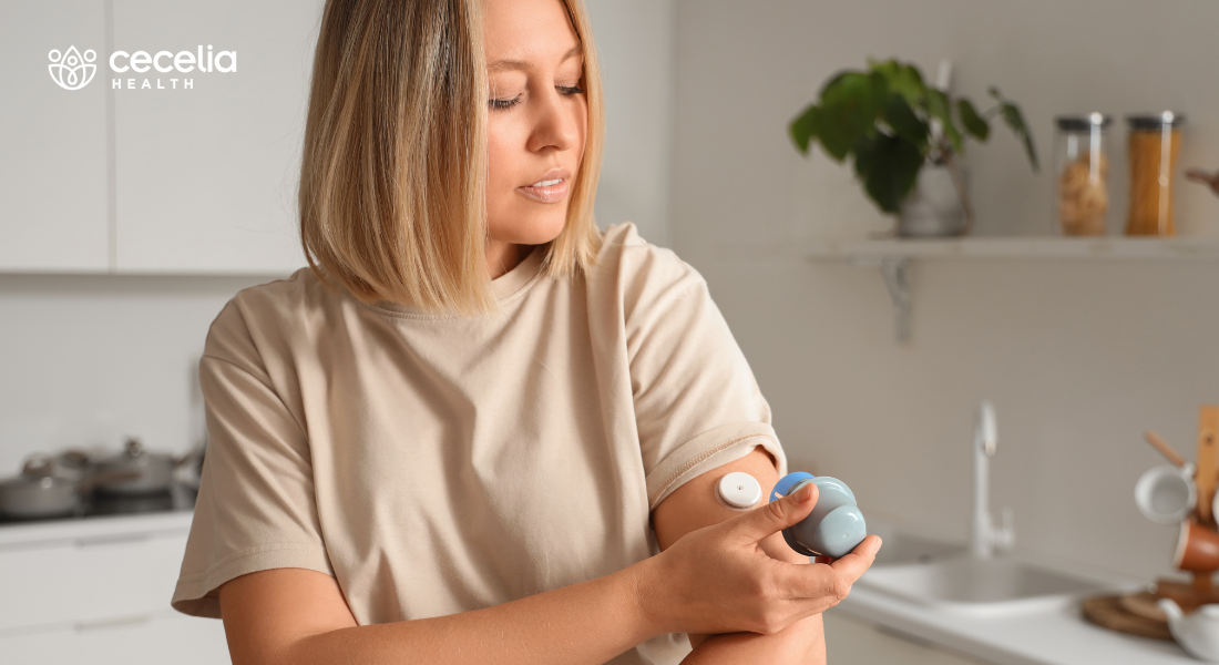 woman using continuous glucose monitor