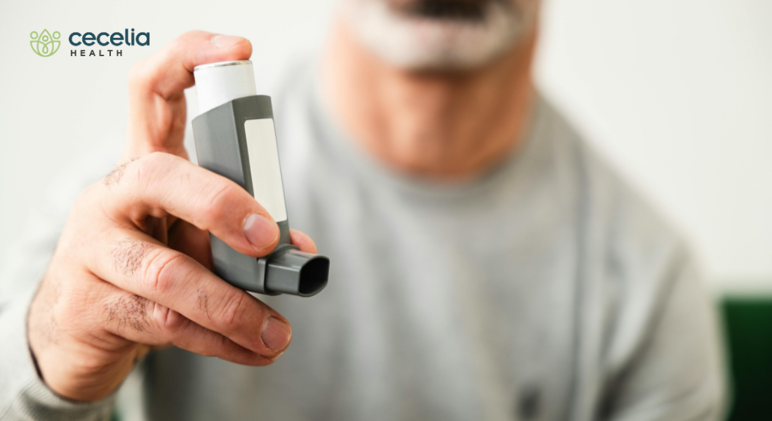 man holding up inhaler