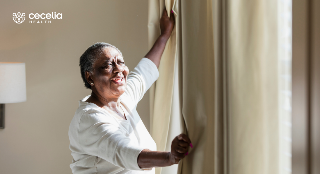 woman opening curtains