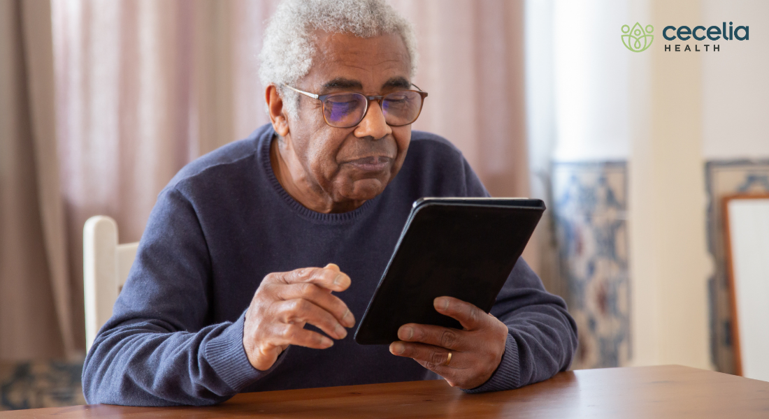 older man looking at tablet