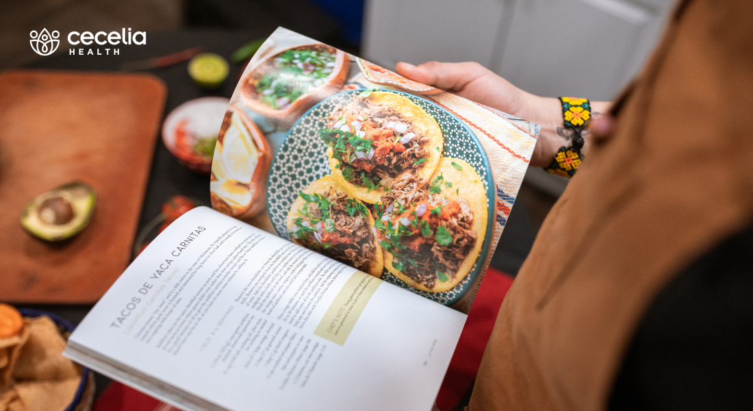 person holding a cookbook featuring image of recipe