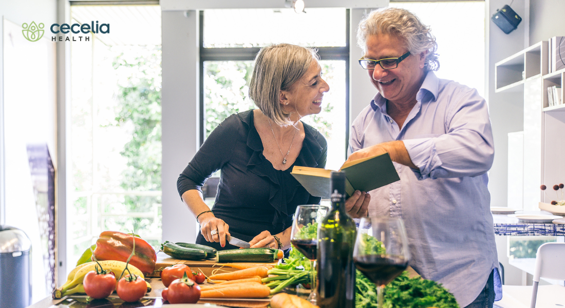 middle age couple cooking vegetables together