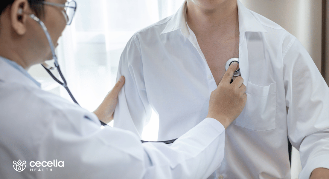 doctor listening to a mans chest with stethoscope