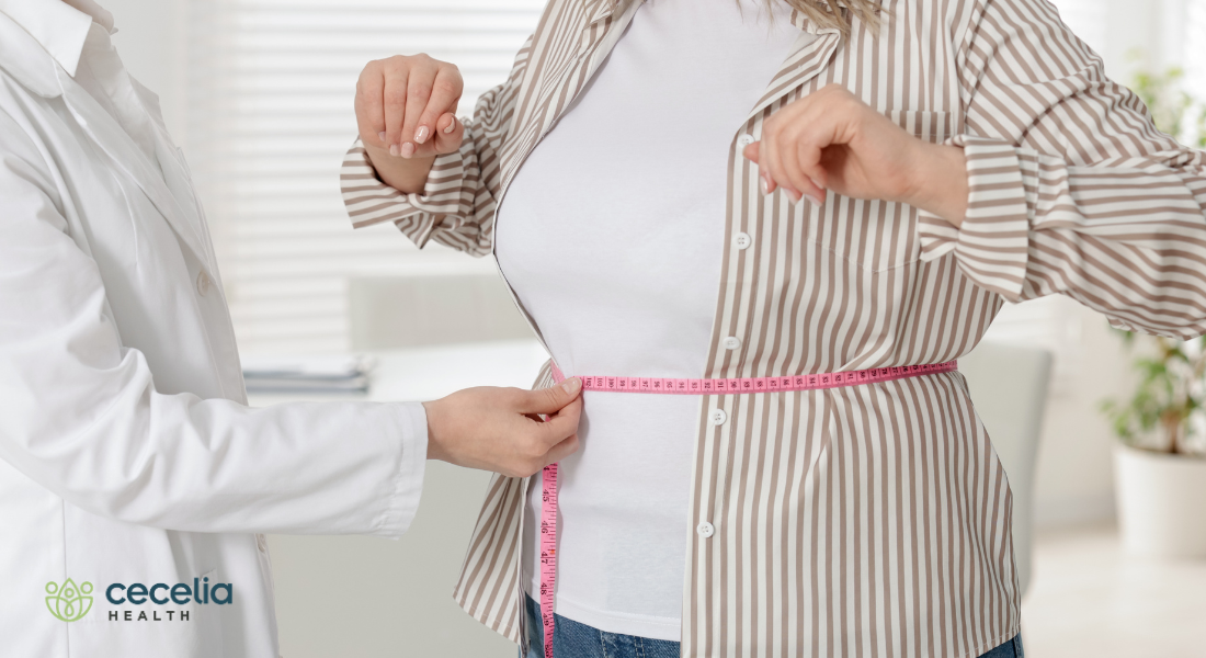 woman getting waist measured by dieitian
