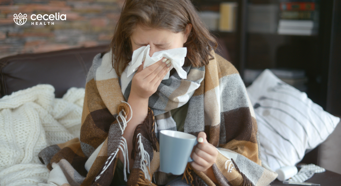 woman sneezing into tissue