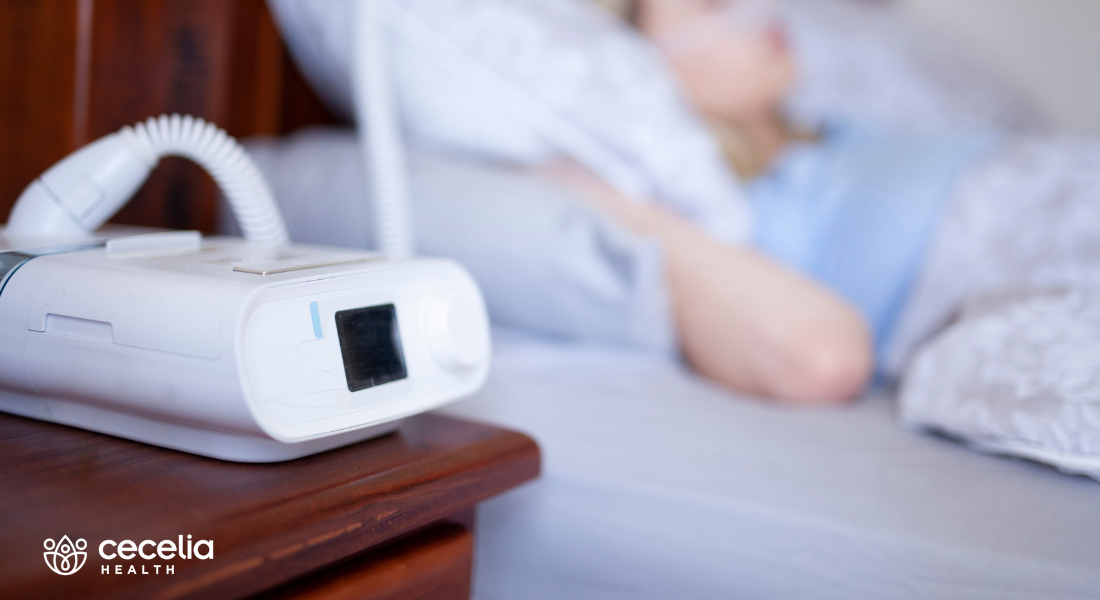 cpap machine with person sleeping in the background