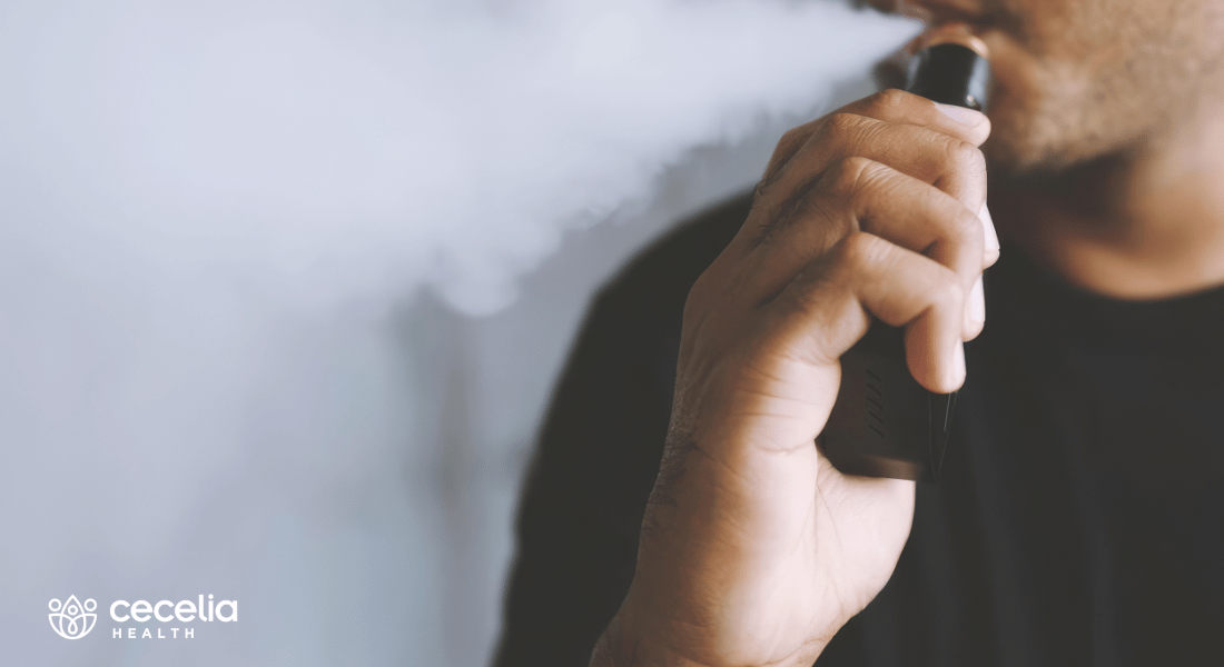 man with vape and smoke