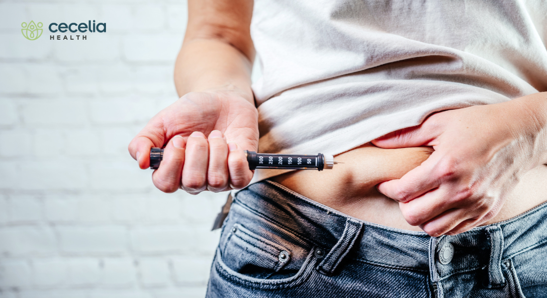 woman injecting medication in abdomen