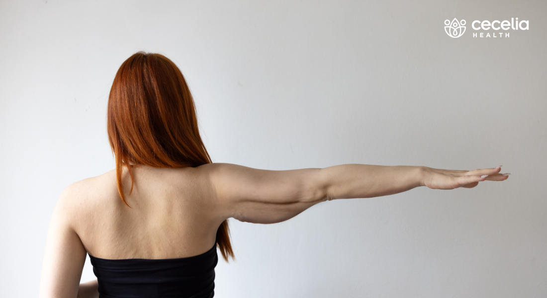 womans back facing camera arm outstretched